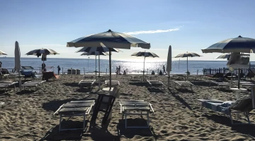 Beach equipped with sunbeds and umbrellas