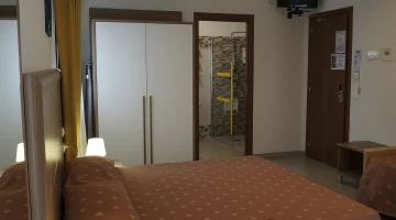 Wardrobe and private bathroom in triple room