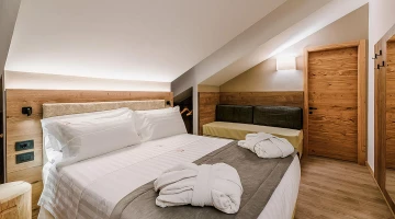 Room with double bed and bathrobe