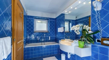 Bathroom with tub and hairdryer