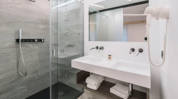 Private bathroom with shower and hairdryer