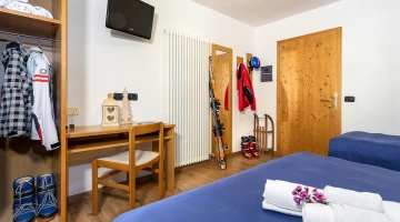 Dreibettzimmer mit TV und Schreibtisch