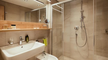 Badezimmer mit großer Dusche im Zimmer