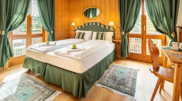 Room with double bed and balcony