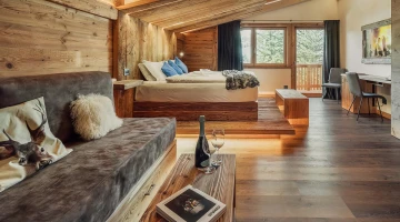 Room with double bed and sofa