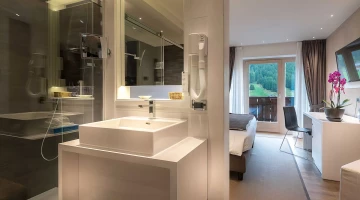 Bathroom with shower and hairdryer in a Suite