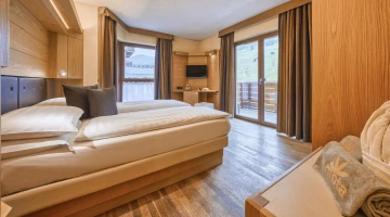 Double bed in room with balcony