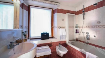 Private bathroom with shower and bathtub