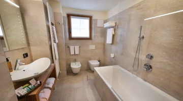 Private bathroom with bath and shower
