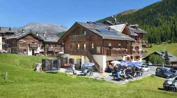 Hotel in summer, with play area and outdoor tables