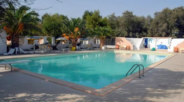 Swimming pool with sun loungers
