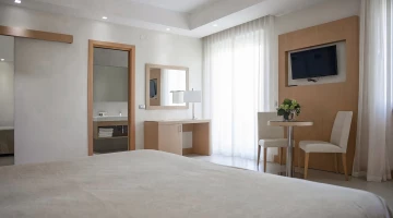 Stanza con TV, balcone e scrivania