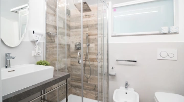 Bathroom with shower and wall-mounted hairdryer