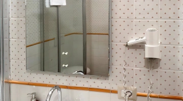 Wall-mounted hairdryer in the bathroom