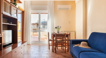 Wohnzimmer mit Tisch und Sofa in einer Zweizimmerwohnung