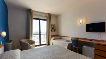 Camera tripla con TV e balcone