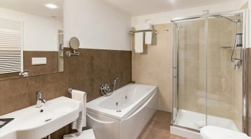 Private bathroom with bathtub and shower