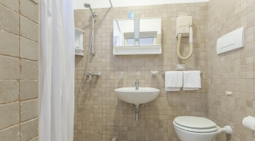 Badezimmer mit Dusche und Wandhaartrockner