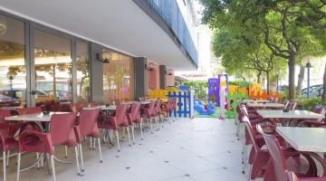 Outdoor area with tables, chairs and children&#39;s outdoor play area