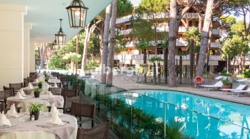 Outdoor dining room with pool view