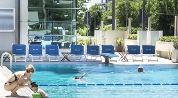 Outdoor swimming pool with children's play area