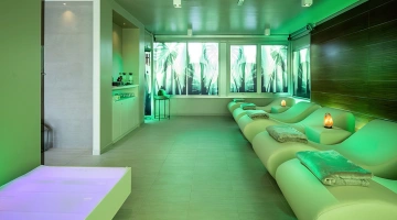 Comfortable chaise longues in the aquamarine spa