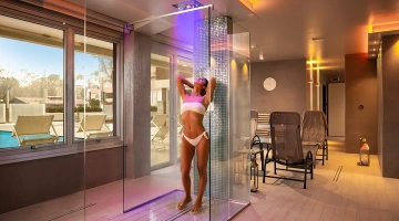 Tropical waterfall and cold rain in the aquamarine spa